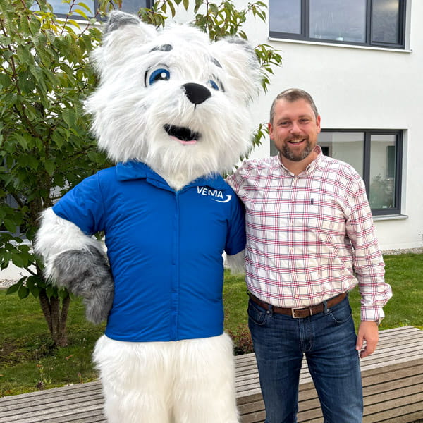 Johannes Neder, Vorstand der VEMA eG, mit dem Maskottchen VEMIL